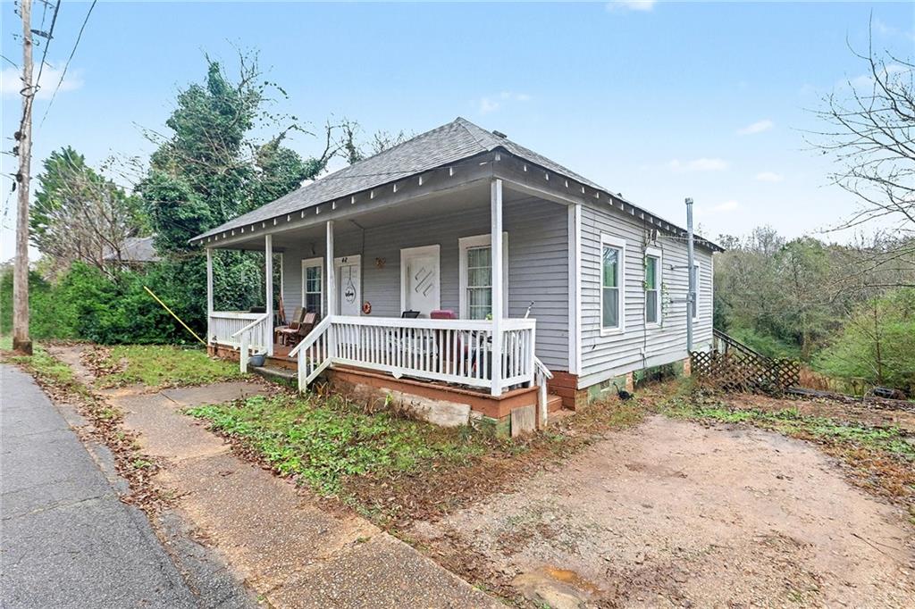 48 Maple Street Grantville, GA 30220 - Photo 3 of 26 a view of a house with a yard and lawn chairs with wooden fence