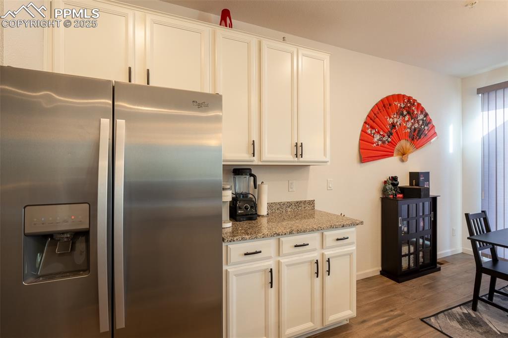 15619 Kitchener Way Monument, CO 80132 - Photo 12 of 40 a kitchen with stainless steel appliances granite countertop a refrigerator and a stove top oven