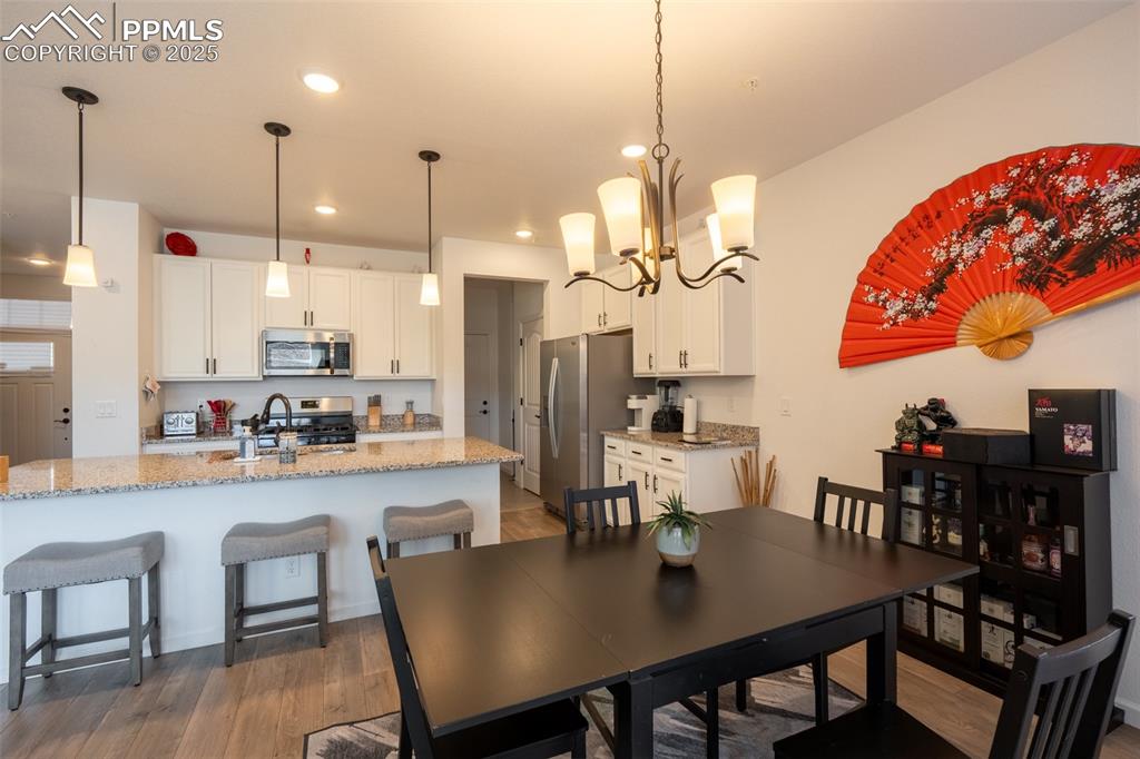 15619 Kitchener Way Monument, CO 80132 - Photo 13 of 40 a dining room filled with furniture and kitchen view