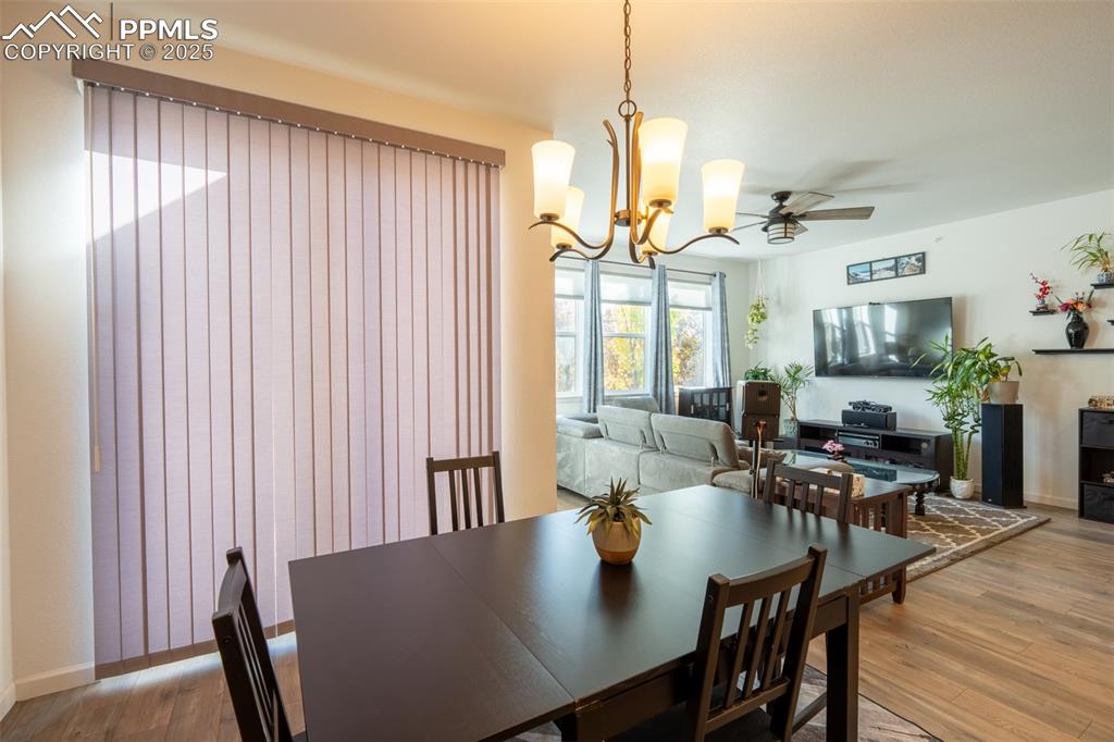 15619 Kitchener Way Monument, CO 80132 - Photo 15 of 40 a view of a dining room with furniture window and wooden floor