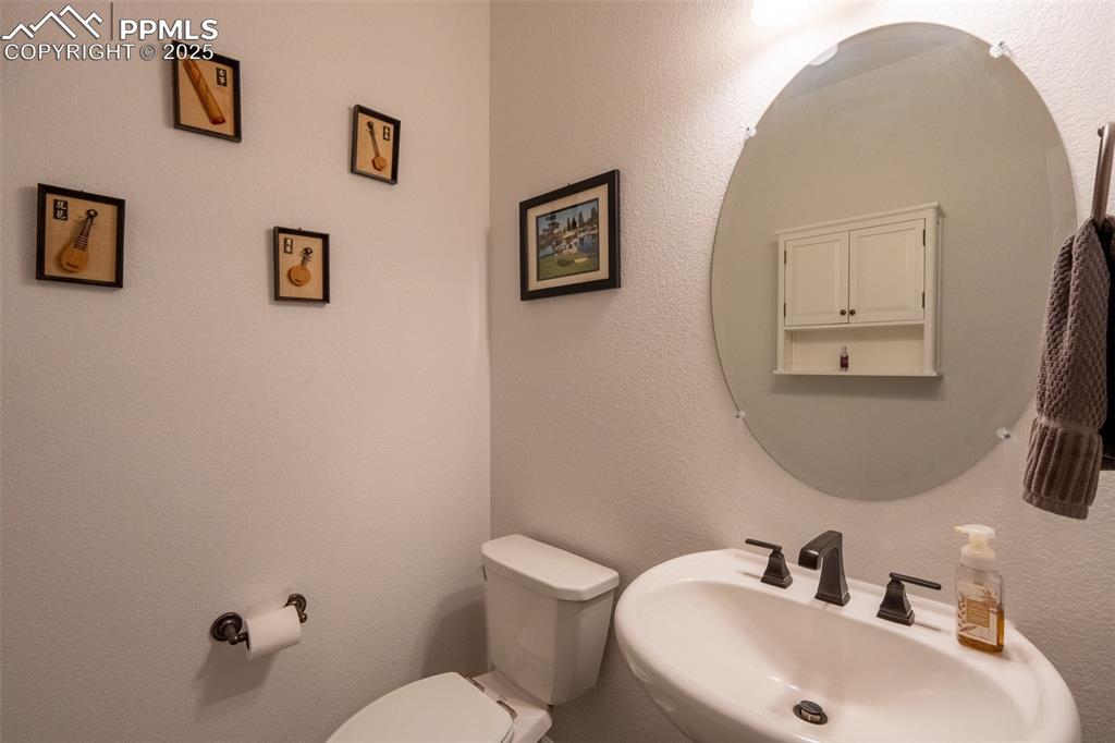 15619 Kitchener Way Monument, CO 80132 - Photo 17 of 40 a bathroom with a toilet sink and mirror