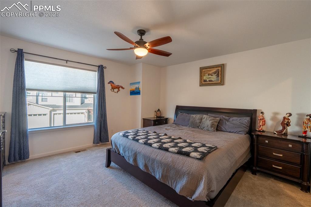 15619 Kitchener Way Monument, CO 80132 - Photo 21 of 40 a bedroom with a bed and a window