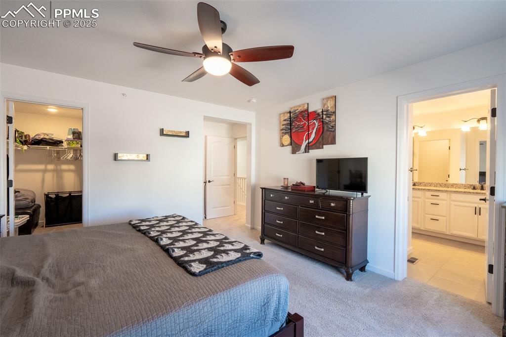 15619 Kitchener Way Monument, CO 80132 - Photo 23 of 40 a bedroom with a bed and a television