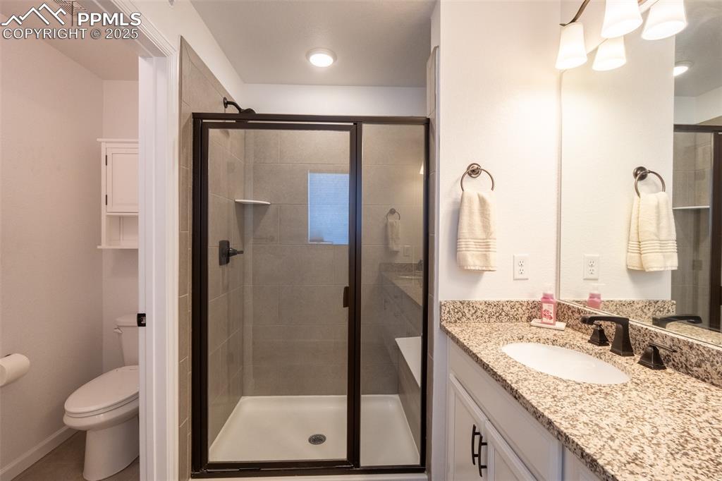 15619 Kitchener Way Monument, CO 80132 - Photo 25 of 40 a bathroom with a granite countertop sink toilet and shower