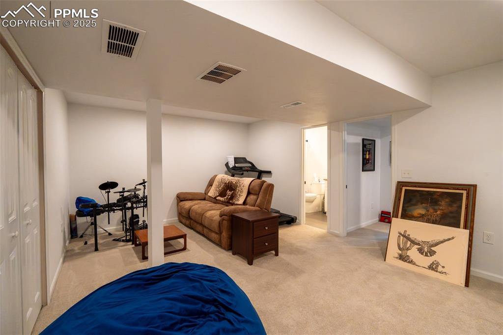 15619 Kitchener Way Monument, CO 80132 - Photo 28 of 40 a living room with furniture and a wooden floor