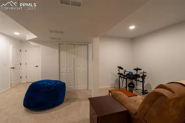 a living room with furniture and a chair