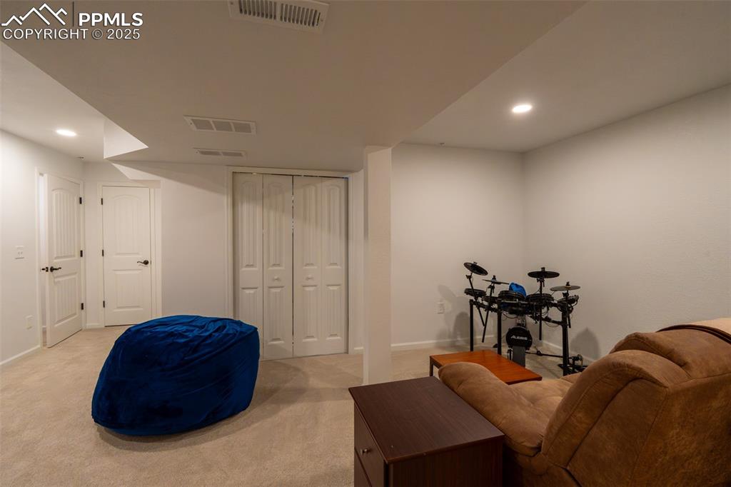 15619 Kitchener Way Monument, CO 80132 - Photo 29 of 40 a living room with furniture and a chair
