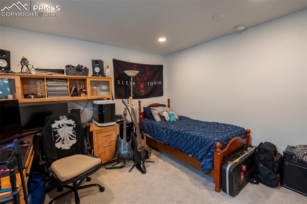 15619 Kitchener Way Monument, CO 80132 - Photo 32 of 40 a bed room with furniture and a chair