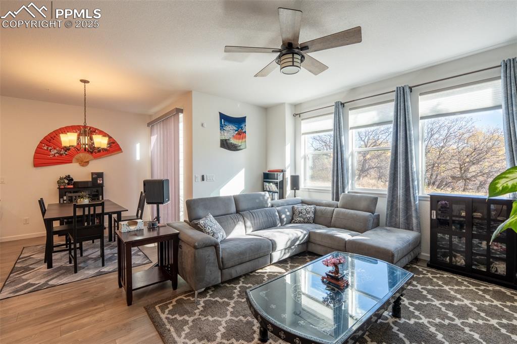 15619 Kitchener Way Monument, CO 80132 - Photo 5 of 40 a living room with furniture a large window and a dining table