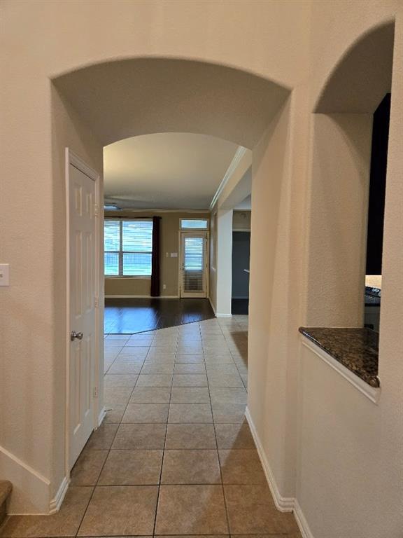 213 Willet Court Little Elm, TX 75068 - Photo 11 of 28 Corridor with arched walkways and light tile patterned floors