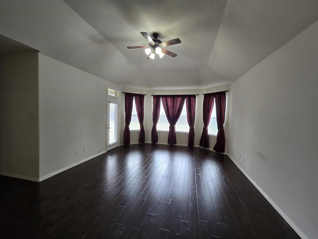 213 Willet Court Little Elm, TX 75068 - Photo 17 of 28 Spare room with a ceiling fan and dark wood-style flooring