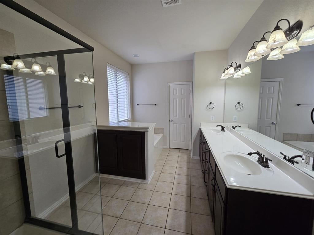 213 Willet Court Little Elm, TX 75068 - Photo 18 of 28 Full bath featuring double vanity, a bath, light tile floors, and a shower