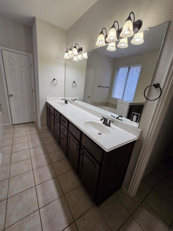 213 Willet Court Little Elm, TX 75068 - Photo 19 of 28 Bathroom with a bath, double vanity, and light tile flooring