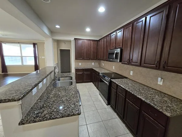 a kitchen with wooden cabinets and a sink