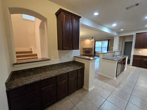 a kitchen with stainless steel appliances granite countertop wooden cabinets a oven and granite counter tops