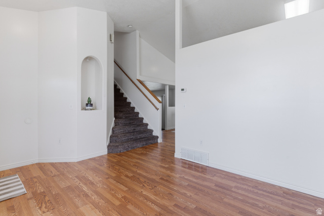 134 West 475 South Ogden, UT 84404 - Photo 3 of 27 Unfurnished living room featuring a high ceiling and light wood-style flooring