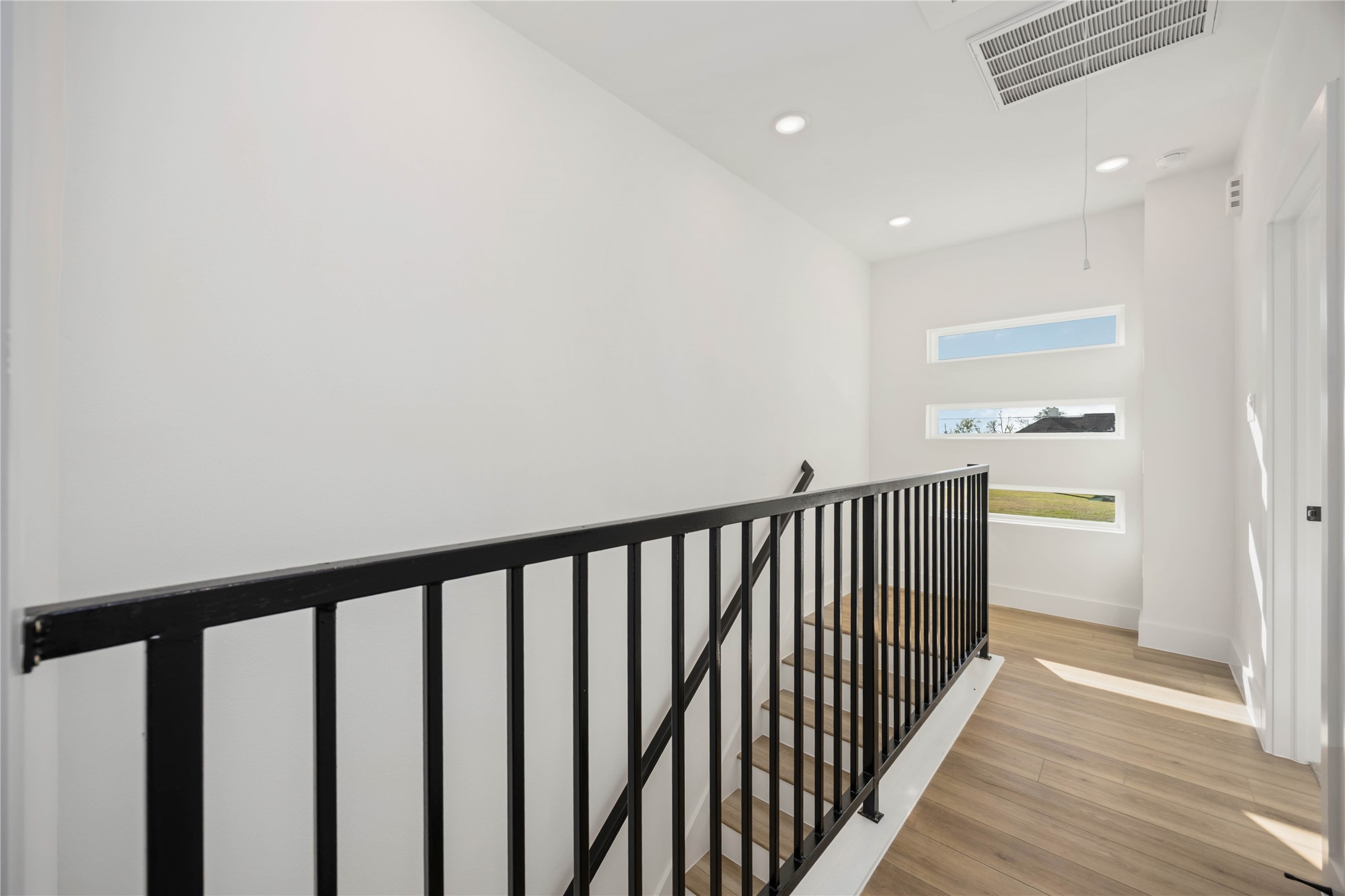 1466 Ferguson Way, Unit B Houston, TX 77088 - Photo 15 of 28 a view of hallway with wooden floor