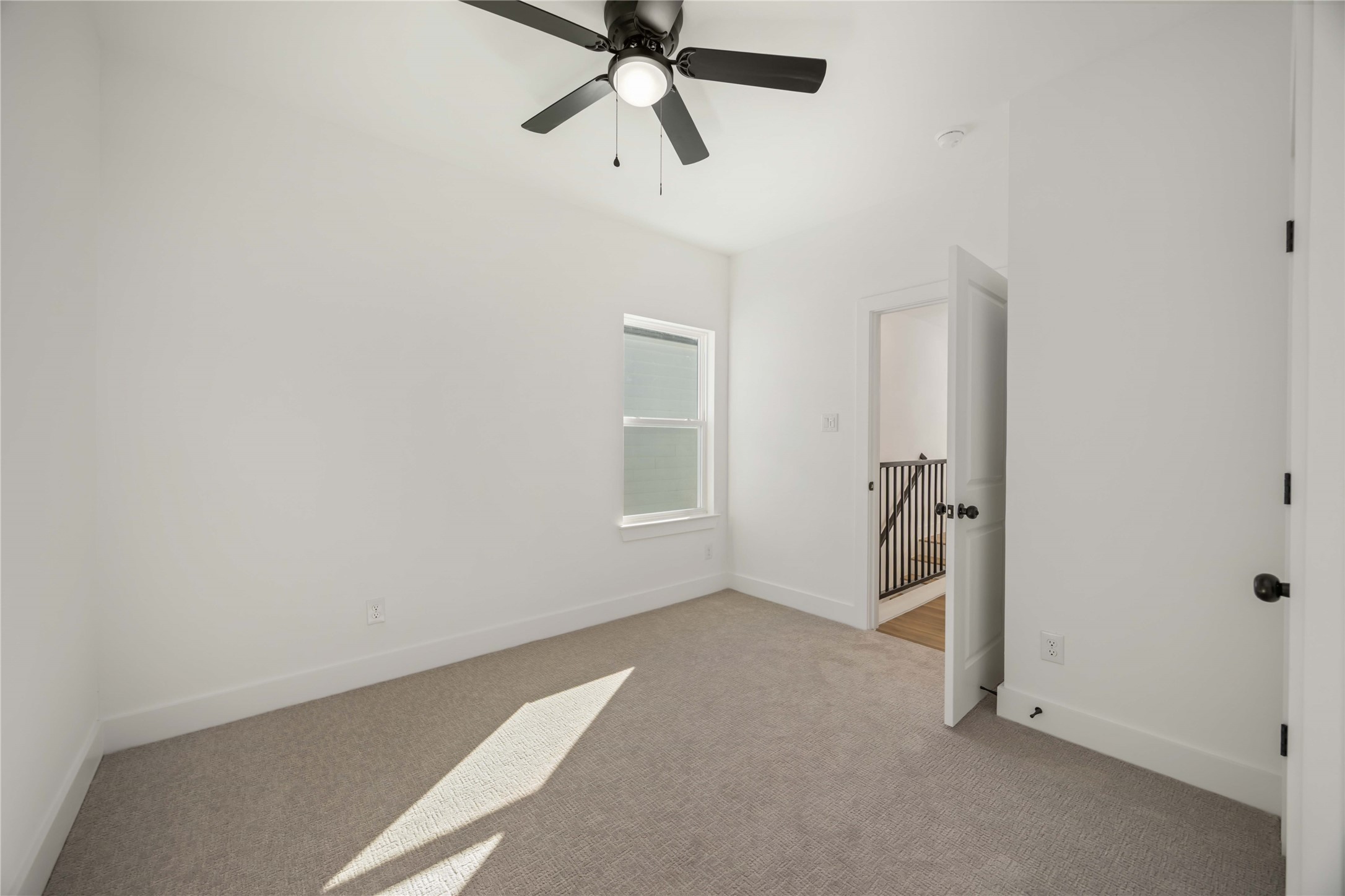 1466 Ferguson Way, Unit B Houston, TX 77088 - Photo 22 of 28 a view of a room with window and ceiling fan