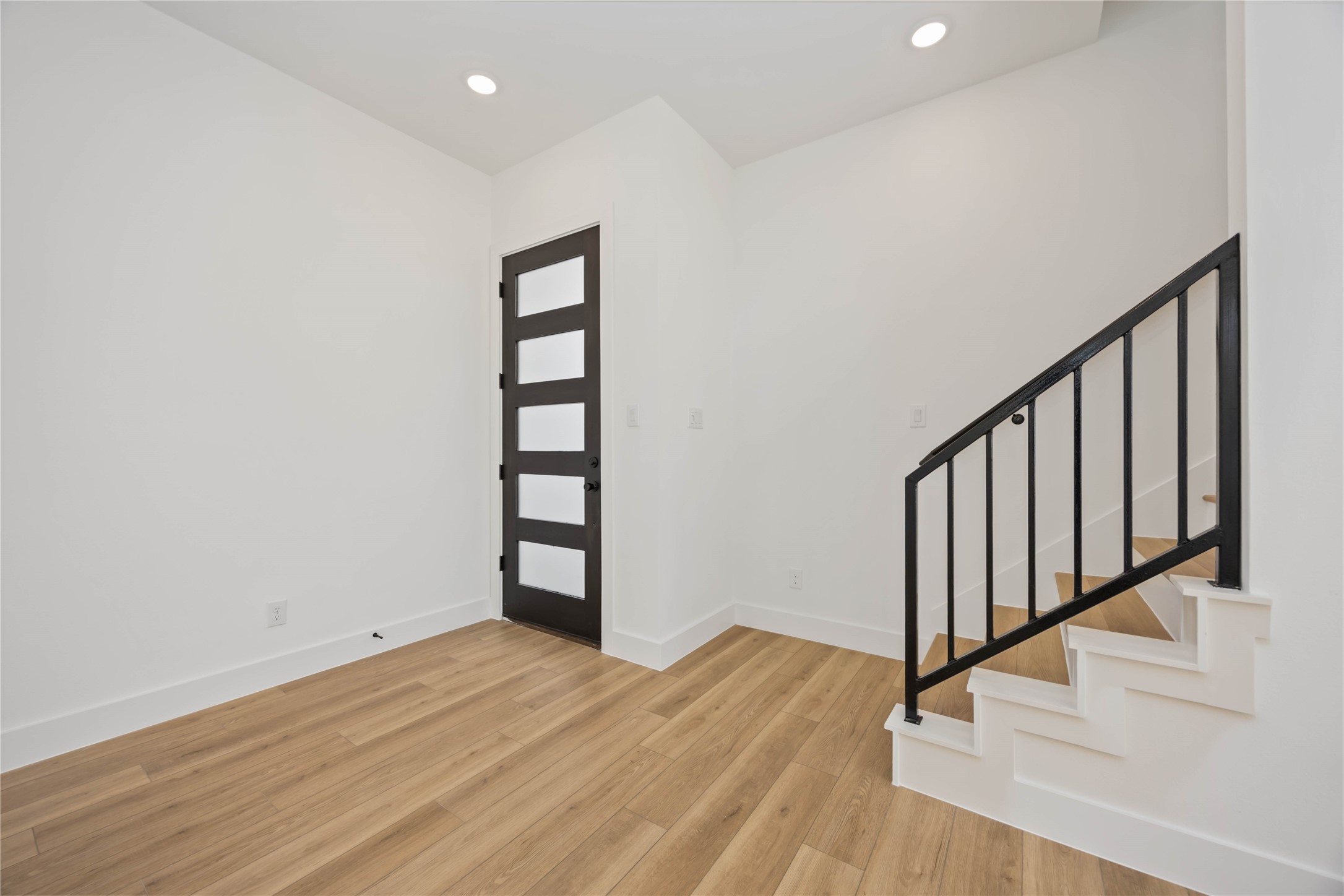 1466 Ferguson Way, Unit B Houston, TX 77088 - Photo 5 of 28 a view of a hallway with wooden floor and staircase