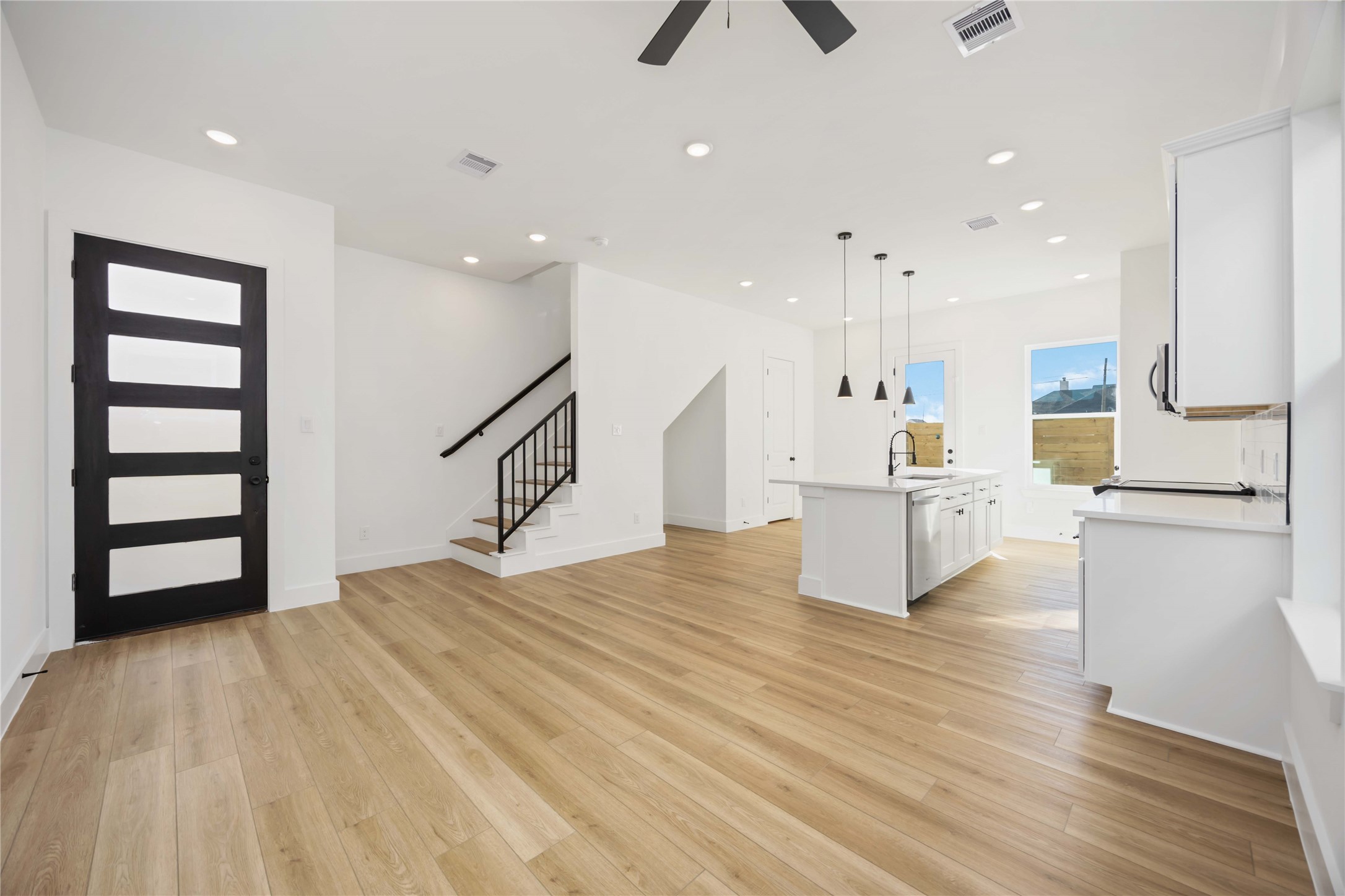 1466 Ferguson Way, Unit B Houston, TX 77088 - Photo 8 of 28 a room with kitchen island stainless steel appliances wooden floor and window