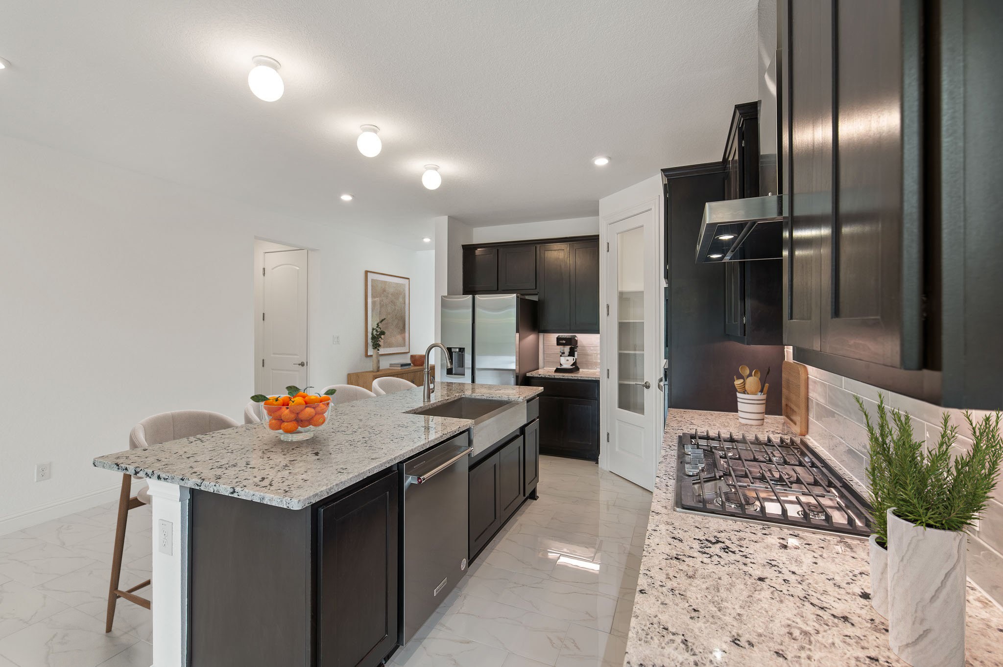 1045 Villa Rialto View Leander, TX 78641 - Photo 11 of 40 Kitchen featuring light marble finish flooring, light stone countertops, a kitchen bar, stainless steel appliances, and a center island with sink