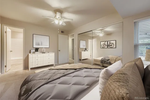 a bedroom with a large bed and a chandelier