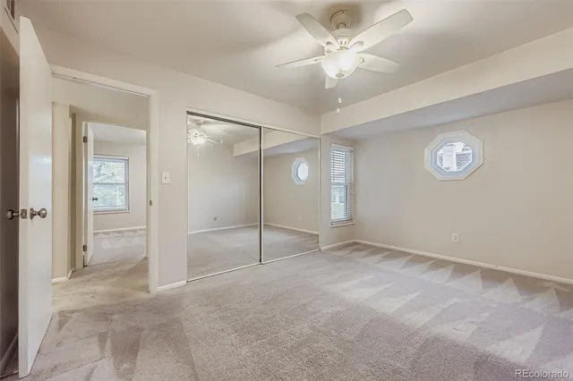an empty room with fan and shower