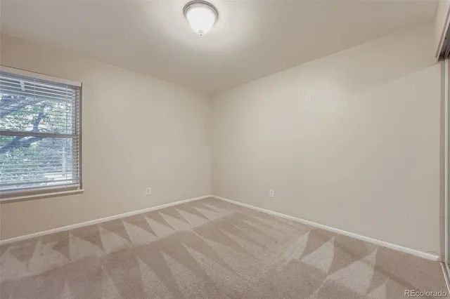 an empty room with mirror in closet