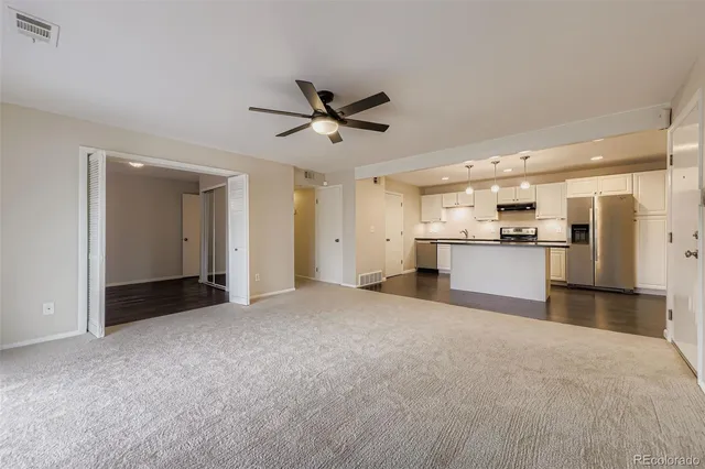 a view of a kitchen with a sink and a refrigerator