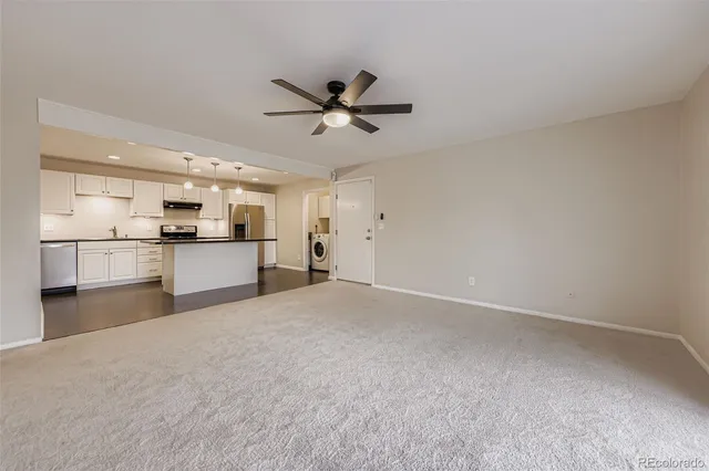 a view of a kitchen with a sink and a refrigerator