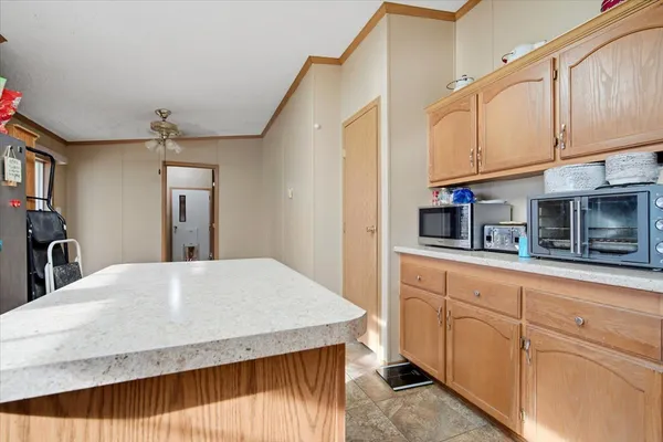 a kitchen with stainless steel appliances granite countertop a sink dishwasher and white cabinets with wooden floor
