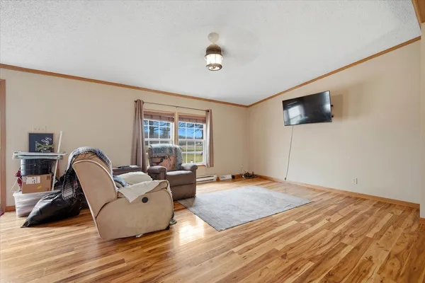 a living room with furniture a flat screen tv and a large window