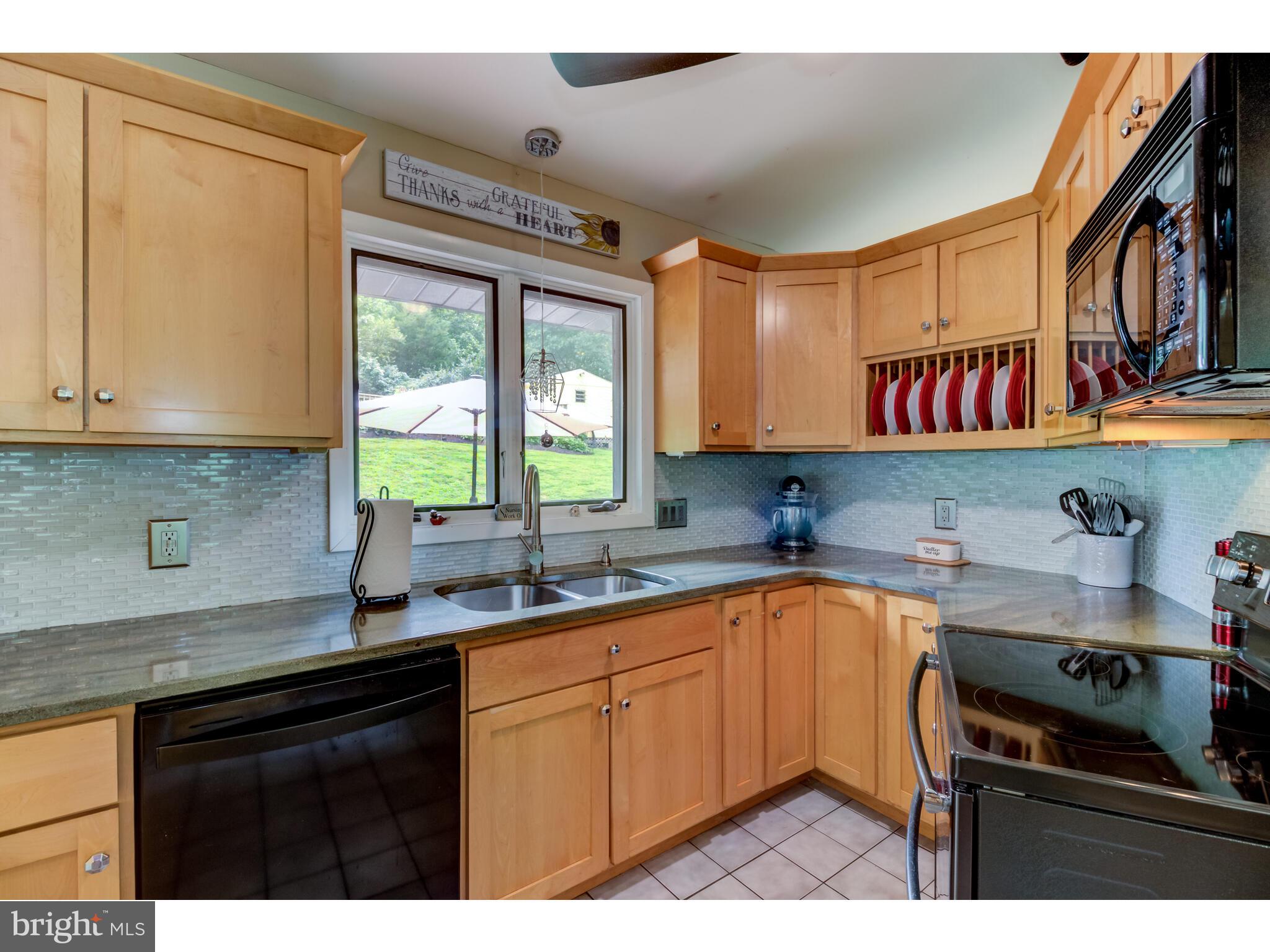246 Chesterville Road Landenberg, PA 19350 - Photo 36 of 62 a kitchen with a sink stove and cabinets