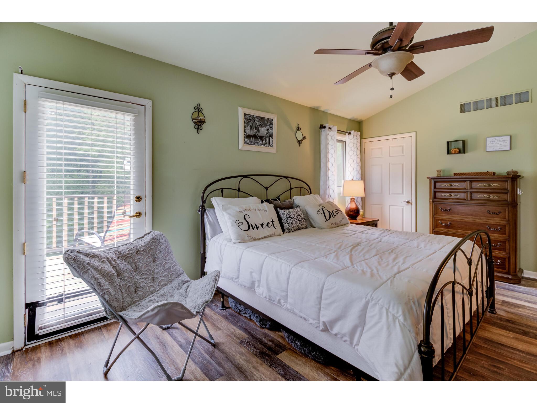 246 Chesterville Road Landenberg, PA 19350 - Photo 46 of 62 a bedroom with a bed a couch and a chandelier