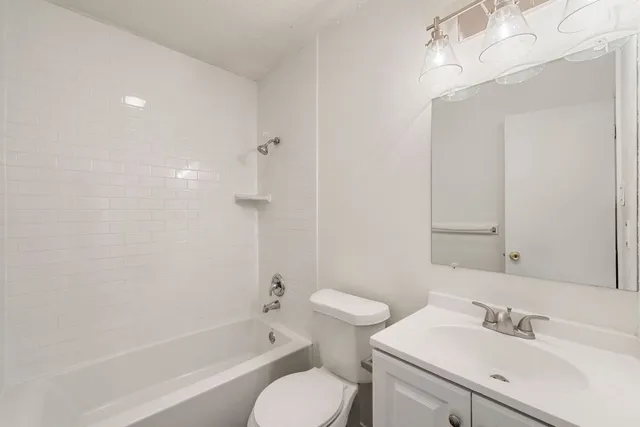 a bathroom with a sink toilet tub and shower