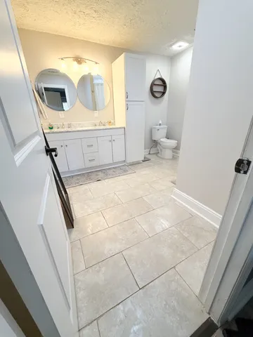 a bathroom with a toilet and a mirror