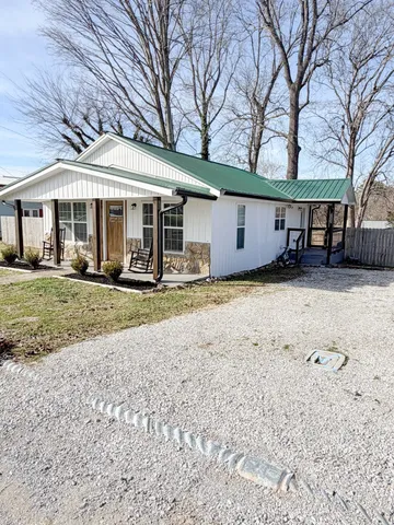 a front view of a house with a yard patio and garage