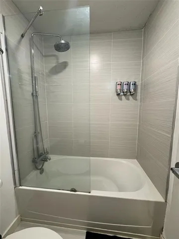 a bathroom with a bathtub and a shower