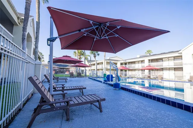 a view of a yard in front of a brick house with a small yard
