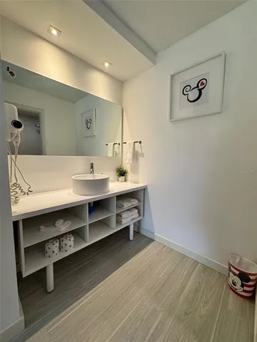 a room with a table chairs and wooden floor