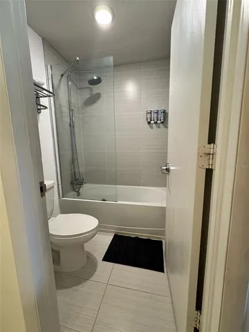 a bathroom with a toilet a sink and a shower