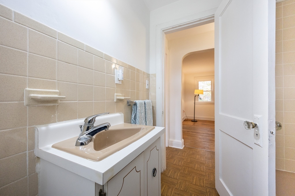 52 Harrison Street Medford, MA 02155 - Photo 11 of 42 a bathroom with a sink and a mirror
