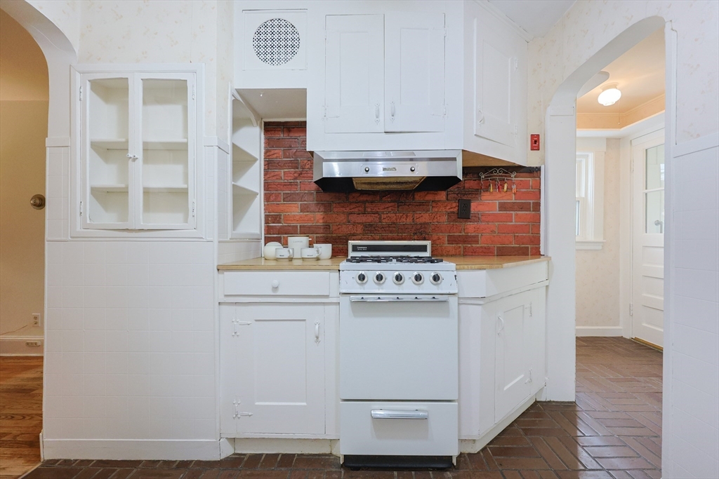 52 Harrison Street Medford, MA 02155 - Photo 16 of 42 a kitchen with stainless steel appliances a stove and a refrigerator