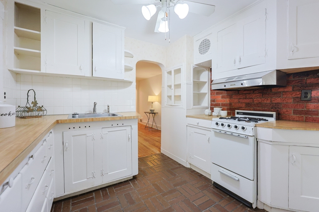 52 Harrison Street Medford, MA 02155 - Photo 17 of 42 a kitchen with cabinets and white appliances