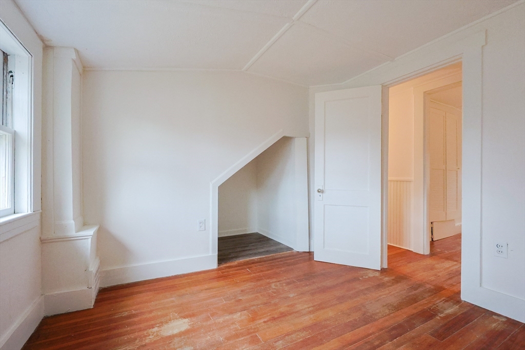 52 Harrison Street Medford, MA 02155 - Photo 33 of 42 a view of an empty room with wooden floor and a window