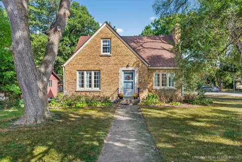 a front view of a house with a garden and patio
