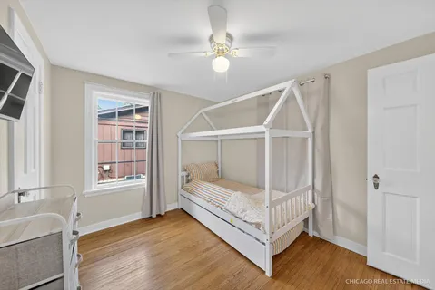 a white bed sitting in a room next to a window
