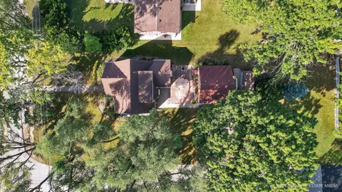 an aerial view of a house with a yard and garden