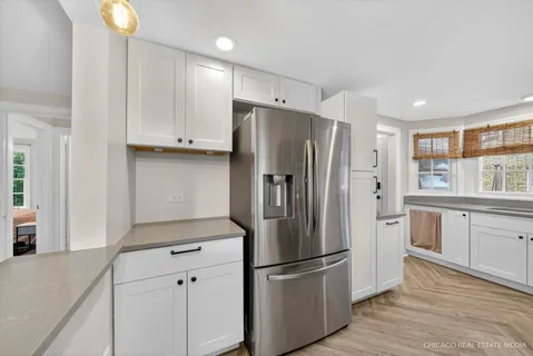 a kitchen with stainless steel appliances a refrigerator sink and cabinets