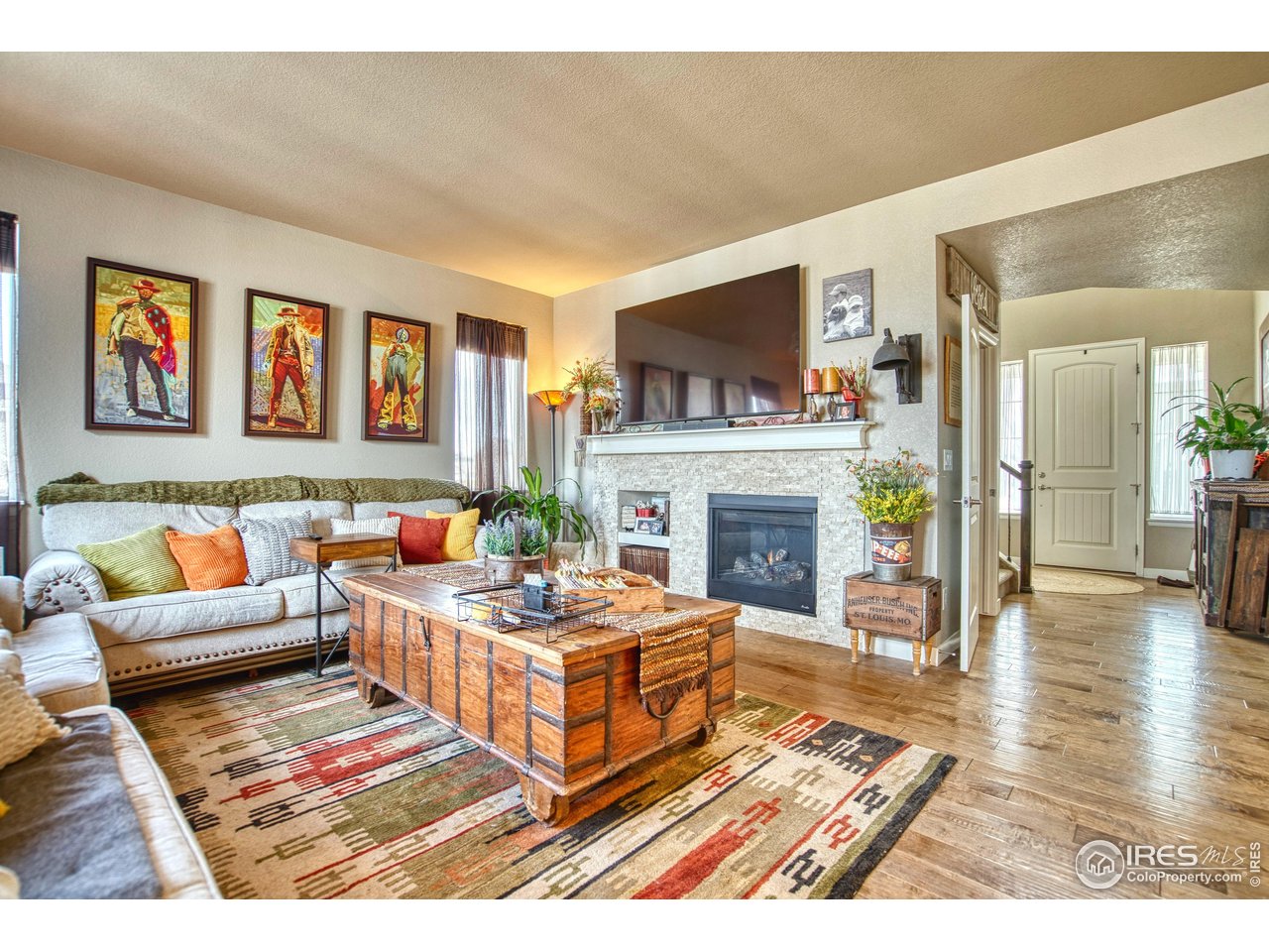 810 Ranchhand Drive Berthoud, CO 80513 - Photo 14 of 40 Gas fireplace w/stacked rock surround is a perfect way to create ambiance.